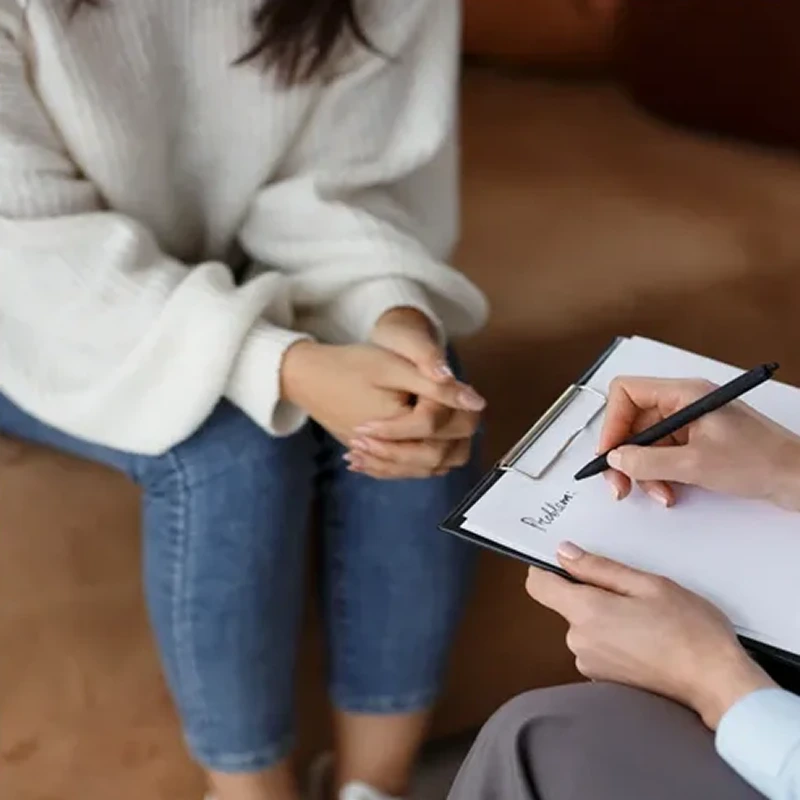 Therapist taking notes during a session – online psychiatry in Alamogordo, NM